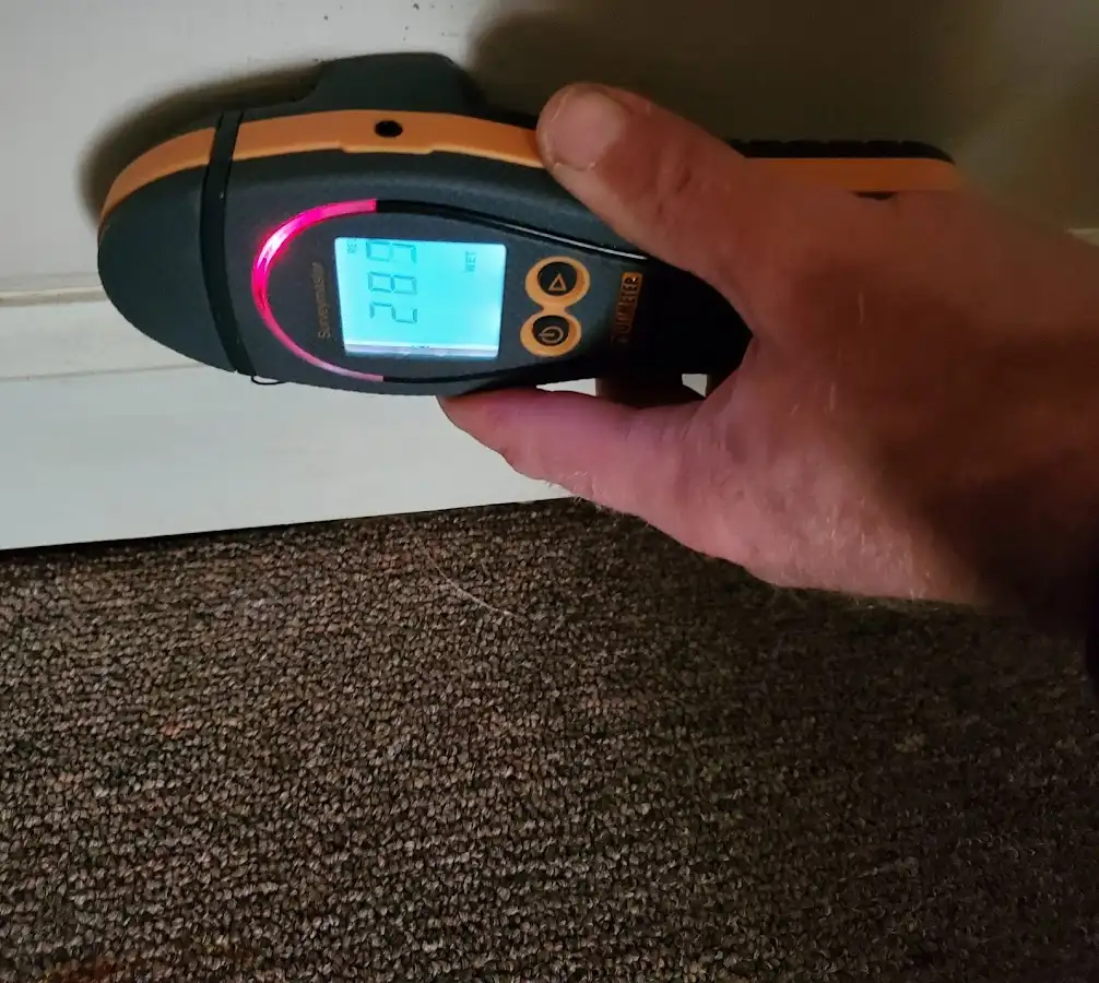 Moisture detection at baseboard during Storm Damage Restoration in Miami